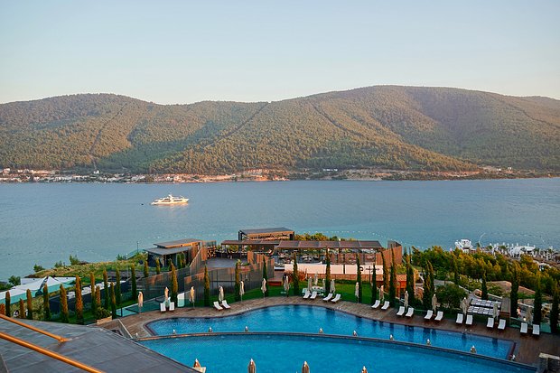 Bodrum, Turkey - August 2020: Hotel beach Lujo. Vacation in Paradise. Beautiful tropical beach banner. White sand travel tourism wide panorama background concept. Amazing beach landscape, yachts