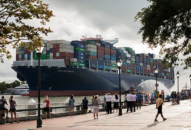 CMA CGM Brazil, one of the largest container ships to call on the U.S. East Coast, sails upriver past Historic River Street and dozens of spectators to the Georgia Ports Authority's Garden City Terminal

