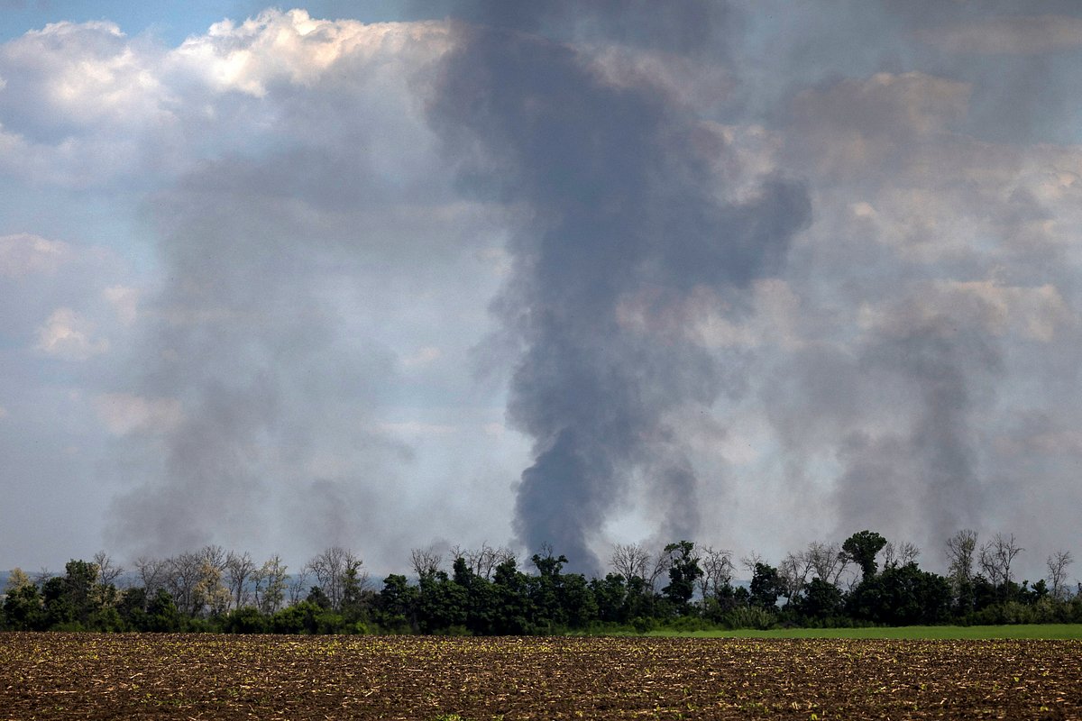 Pillars of smoke rise over a tree line in a field in the Kharkiv region, amid Russia's attack on Ukraine, in Ukraine, May 20, 2024. 