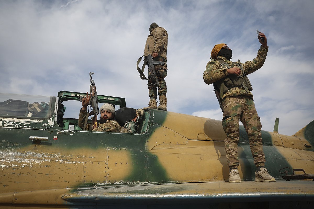 Syrian opposition fighters stand atop a seized Syrian Air Force fighter plane at the Hama military airport, Syria, Friday Dec. 6, 2024. (AP Photo/Ghaith Alsayed)


