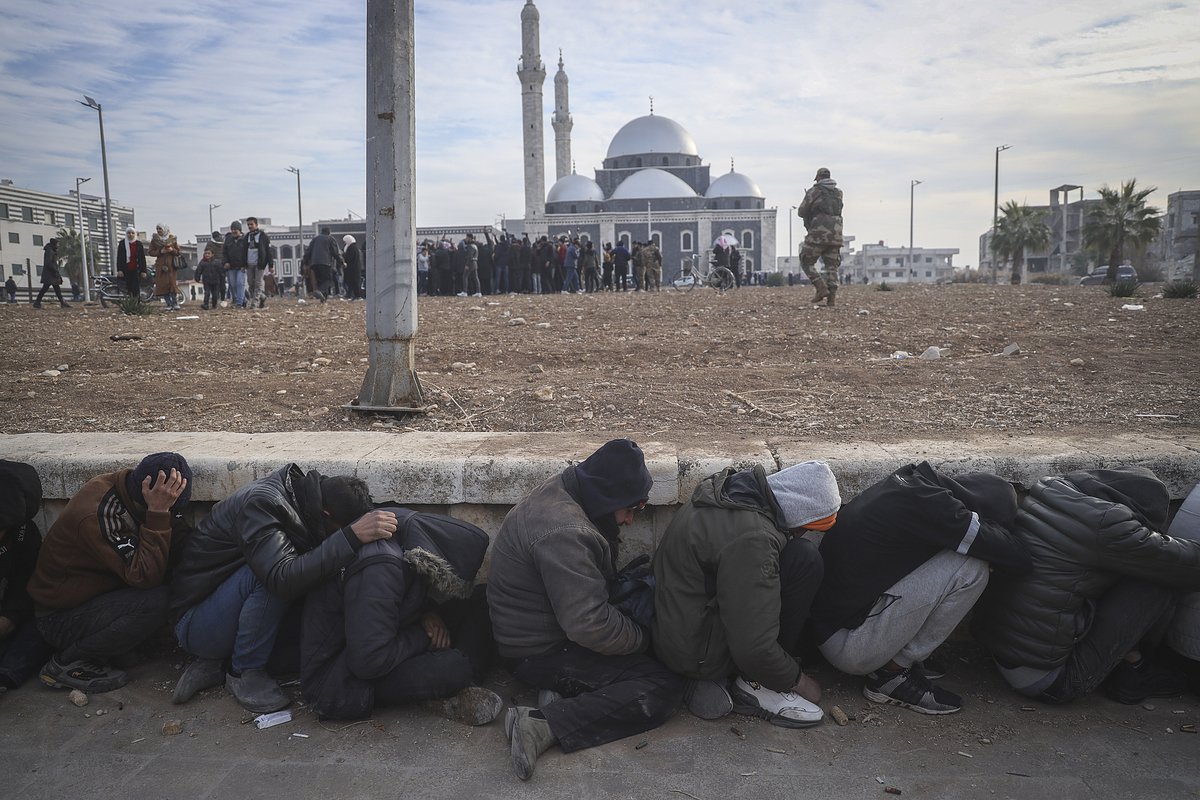 Government soldiers and their allies huddle on the ground while being detained by insurgents in Homs, Syria, Sunday Dec. 8, 2024. (AP Photo/Omar Albam)


