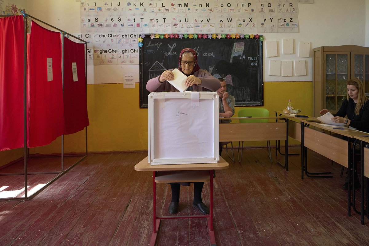 Elena, 76 years old casts her vote in the second round of the country's presidential election redo in Popesti, Romania, Sunday, May 18, 2025.