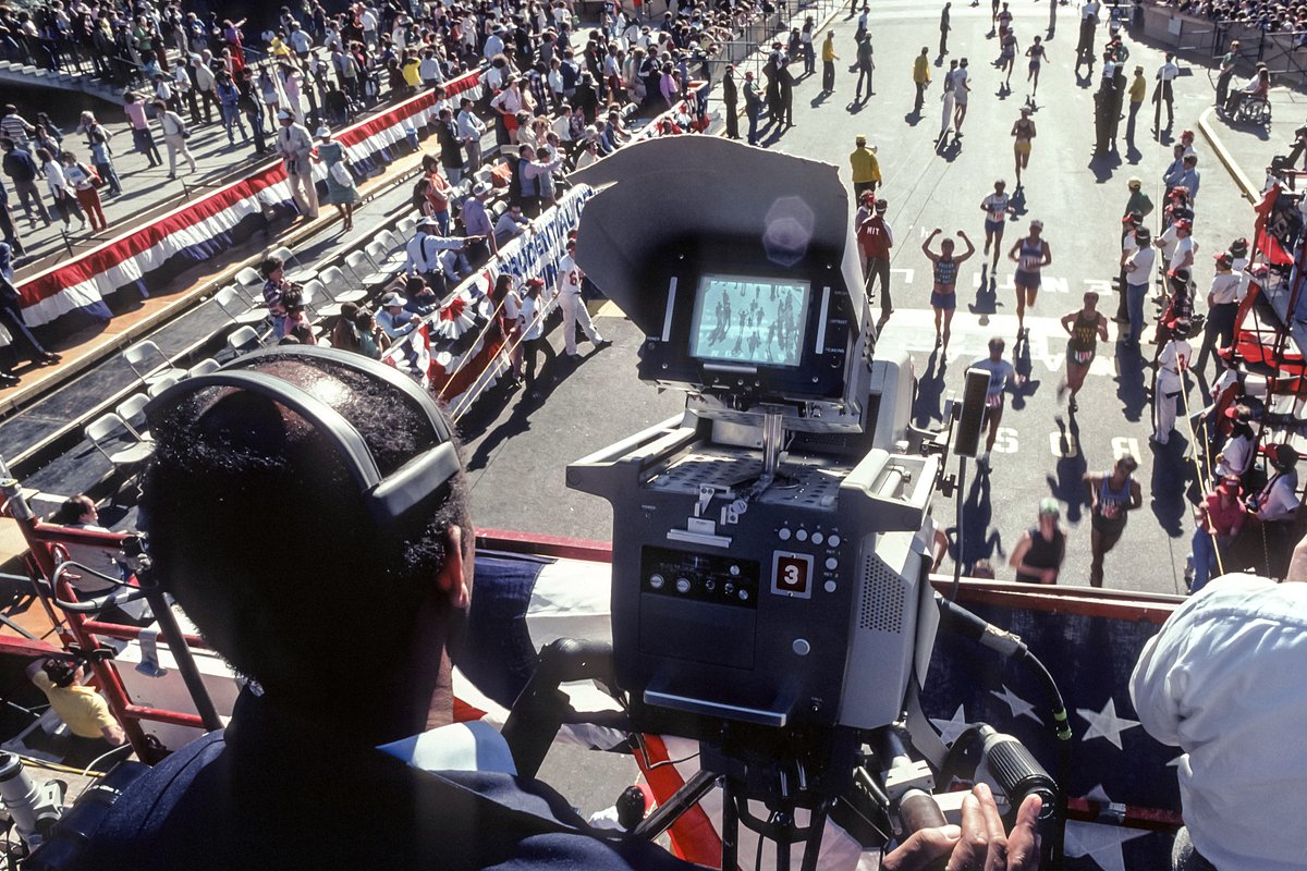 A television camera operator covers the 84th Boston Marathon on April 21, 1980 from the photo bridge above the finish line on Boylston Street in Boston, Massachusetts