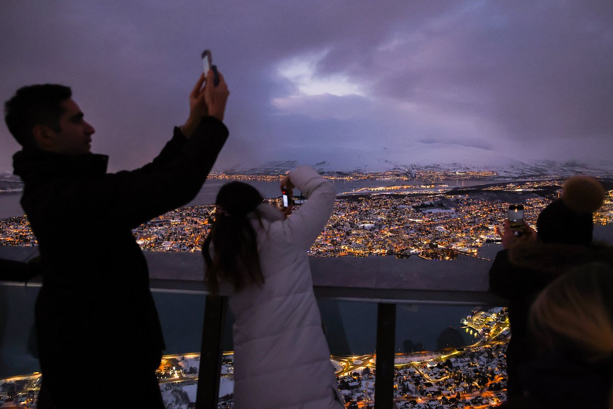 Туристы наблюдают за северным сиянием в Норвегии