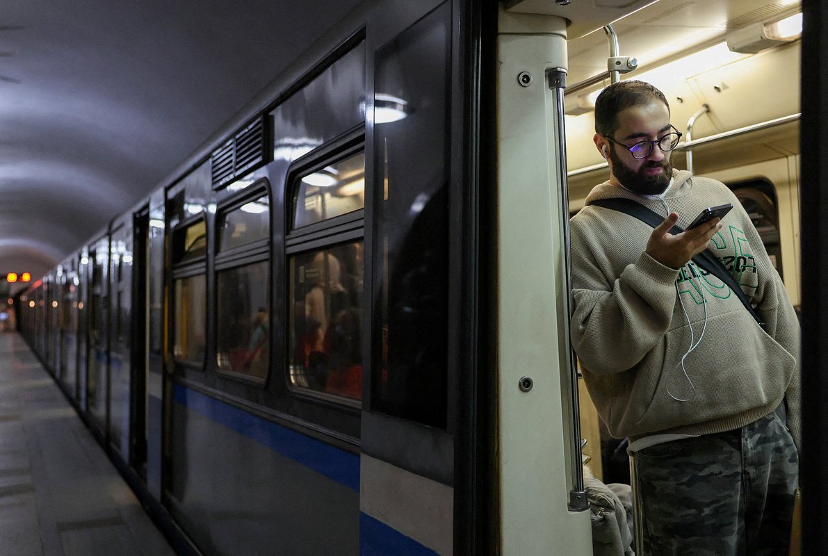 A passenger uses a mobile phone in a metro carriage in Moscow, Russia, March 31, 2026. 