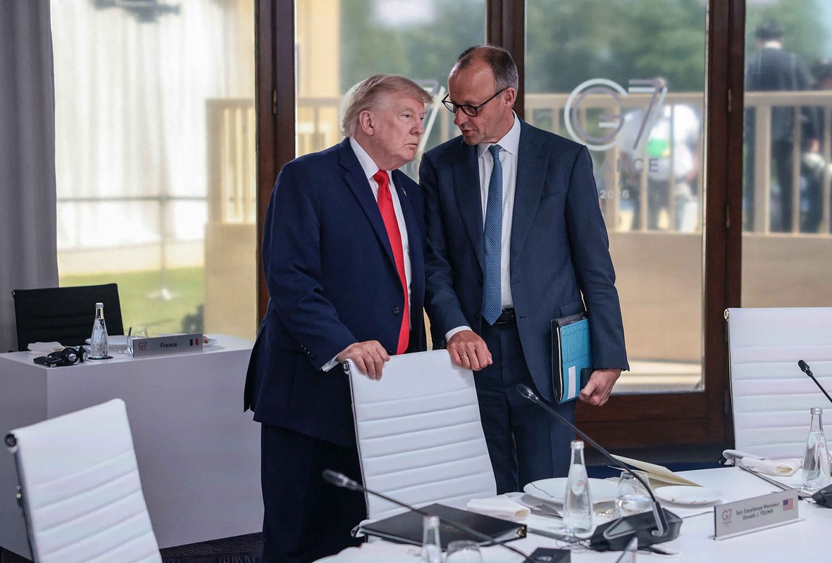 U.S. President Donald Trump speaks with German Chancellor Friedrich Merz at a working lunch with leaders of G7 and the Middle East, in Evian-les-Bains, France, June 16, 2026. 