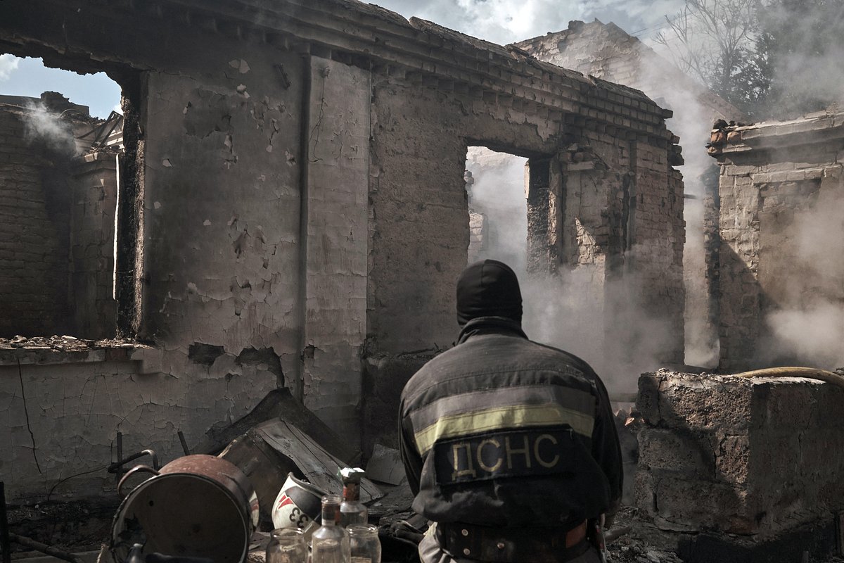  Rescuers, police, medics and utility workers work at the site of a Russian night attack