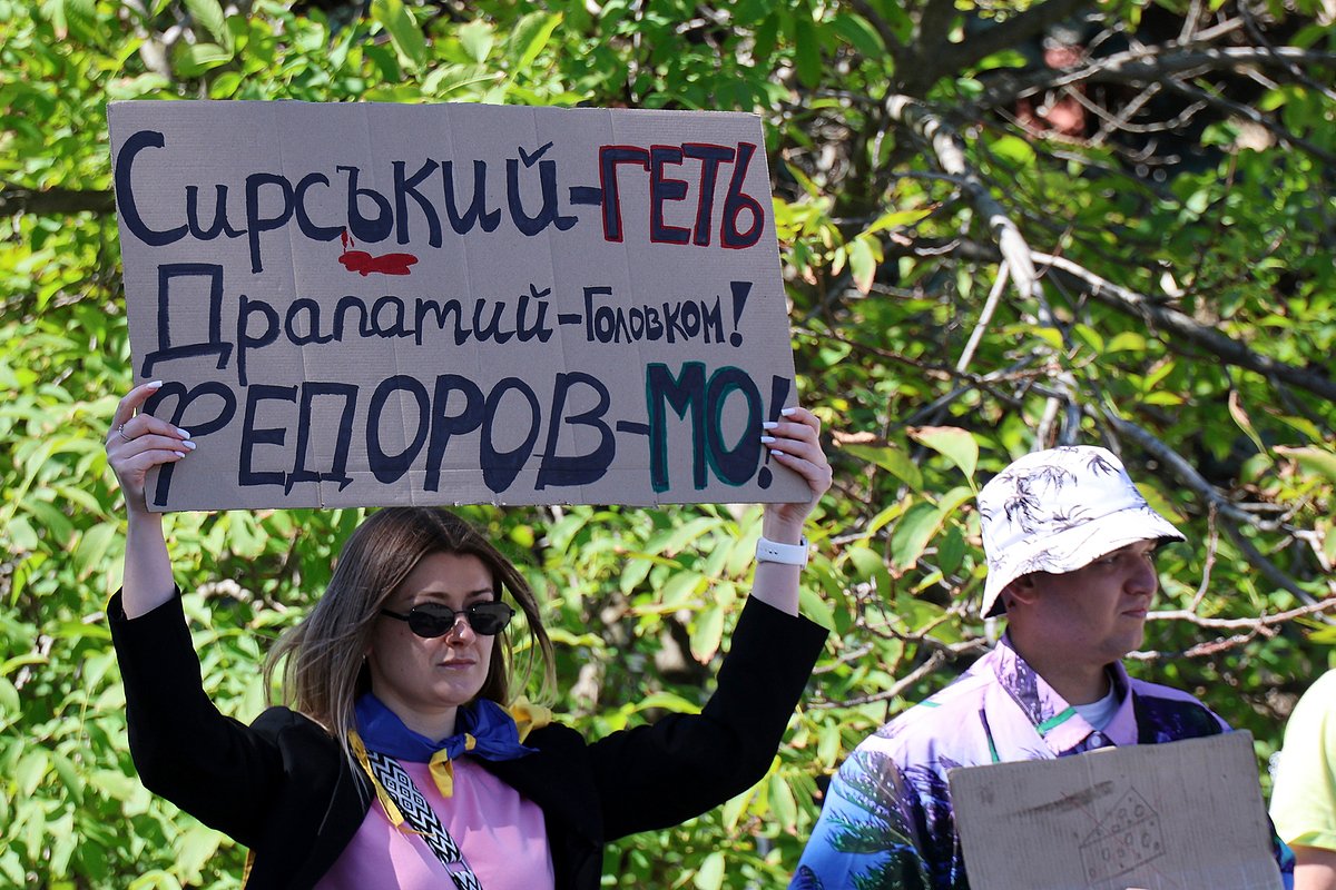 Протестующая держит плакат с надписью «Сырского — в отставку! Драпатого — главнокомандующим! Федорова — министром обороны!», Харьков, Украина, 17 июля 2026 года