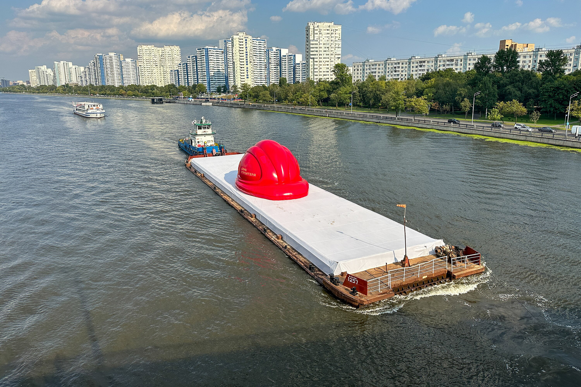 A giant red hard hat floats along Moskva River in Moscow